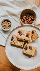 A plate of four peanut butter and jelly sandwiches sits on a wooden table