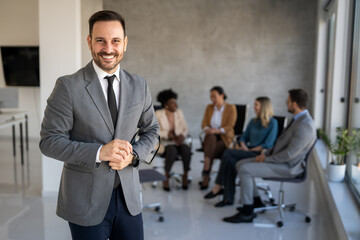 Confident businessman in modern office wearing suit and tie, showcasing executive leadership