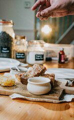 A person sprinkling sugar on a plate of food