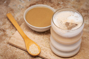 Coffee with sesame paste tahini in a cup on the Travertine table