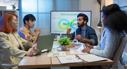 Diverse business team meeting in modern office to discuss sustainability, ESG goals, and eco-friendly strategies focused on green initiatives, environmental responsibility, and corporate ethics.