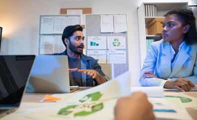 Diverse business team meeting in modern office to discuss sustainability, ESG goals, and eco-friendly strategies focused on green initiatives, environmental responsibility, and corporate ethics.