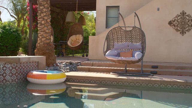 Pool floaty in a backyard pool with lounge chairs palm springs california