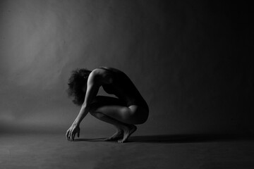 Black and white artistic portrait of a woman’s body with hands and shadows