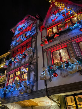 Strasbourg, France - December 20, 2022: A beautifully decorated facade of "Le Gruber" restaurant glows with Christmas lights and ornaments, capturing the magic of the Advent season