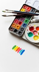 Watercolor Paint Set with Brush and Color Swatches on White Background