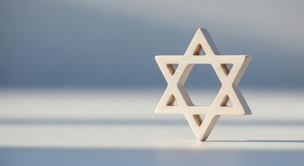Star of David wooden symbol on white background with soft light  