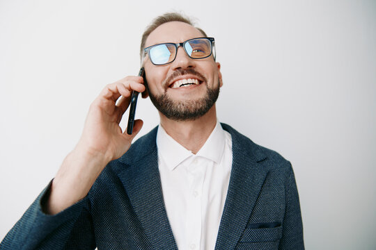 Professional business man on a call, smiling with confidence against an isolated colored background. The scene conveys optimism, focus, and approachability for corporate communication and leadership