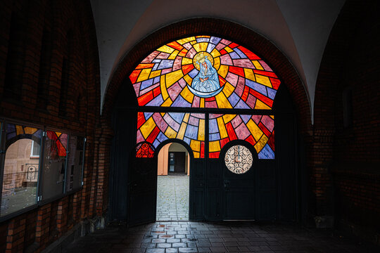 Stained glass archway in Tarnow Church of the Holy Family gate featuring vibrant mosaic window design in Poland with bright colors
