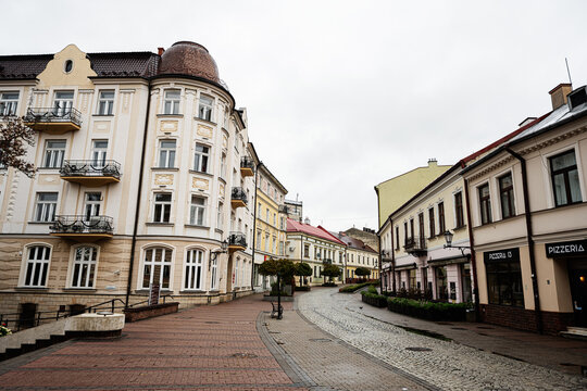 Charming historic street in Tarn&oacute;w Poland with colorful facades, cafes, and cobblestone charm