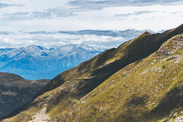 lights and shadows over the meadows with alps in the background