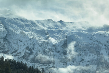 Obraz premium Snow-covered alpine landscape in Austria with Radstadt Tauern mountains in winter