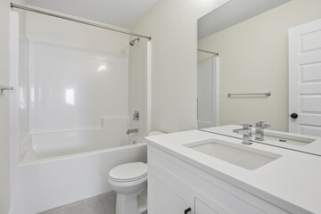 Bathroom with a white toilet, sink, and bathtub