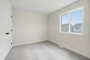Bedroom with a white door and a window