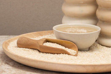 Tahini Latte. Coffee with sesame paste tahini in a cup on the Travertine table