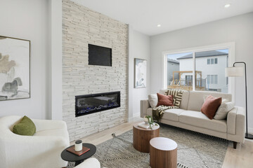 Living room with a fireplace, a couch, and a chair