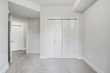White room with a white door and white closet