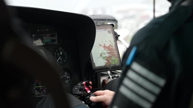 Pilot Hand on Helicopter Flight Controls with Navigation Tablet