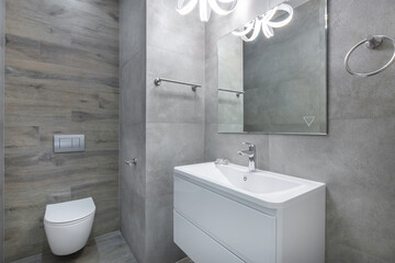 Modern bathroom design featuring sleek fixtures and neutral tones in a spacious layout with stylish lighting