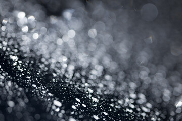 water drops on glass in close-up. abstract dark background with beautiful bokeh. Mockup for your logo. horizontal wallpaper or web banner.