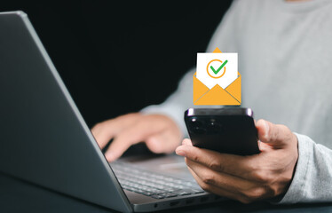 Businessman using smartphone holding. ocusing on email with checkmark icon, symbolizing email verification, secure communication, and digital identity.