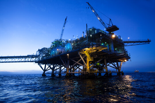 Offshore Oil Rig at Sunset over Ocean &ndash; Industrial Energy Platform for Oil and Gas Production