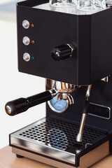 Modern black coffee machine brewing espresso in a stylish home kitchen