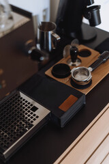 New black coffee machine prepares espresso in a modern kitchen setup