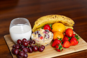 Fresh Fruit Salad with Milk Delight on Wooden Table