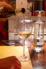 Drinking of white wine in restaurant for dinner, glasses of white wine in Italy, France, European lifestyle
