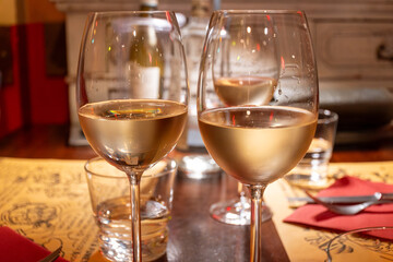 Drinking of white wine in restaurant for dinner, glasses of white wine in Italy, France, European lifestyle