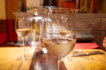 Drinking of white wine in restaurant for dinner, glasses of white wine in Italy, France, European lifestyle