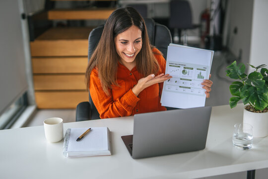 Woman presenting financial data during remote video call - Powered by Adobe