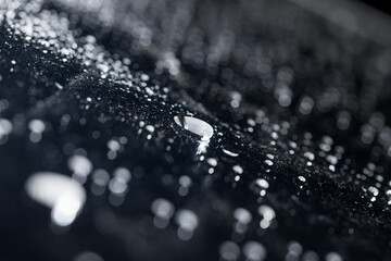 raindrops on a dark background.water drops on glass in close-up. Abstract dark background. Mockup...