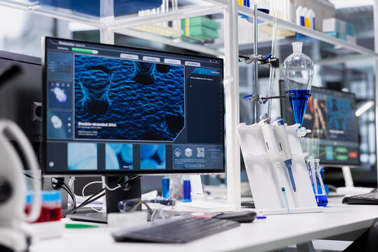 Computer monitor in biotechnology laboratory showing 3D molecular model visualization used for research. High tech bioengineering software on PC in medical lab displaying DNA data