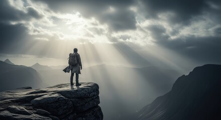 Epic view of a solitary adventurer on a rocky precipice, gazing at majestic sun rays illuminating a mountainous valley