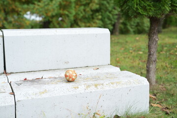A white bench with a ball on it