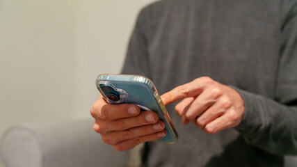 22-10-2025 Coventry, Uk. Man using smartphone scrolling social media content