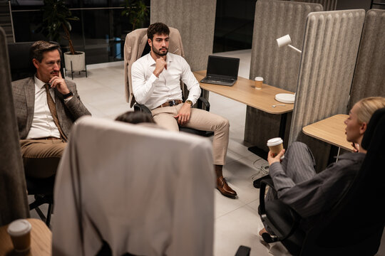 Business professionals discussing work in modern office