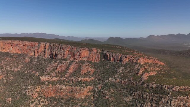 Flinders Ranges, South Australia &ndash; 4K Aerial Drone Footage of Rugged Red Cliffs, Rocky Hills, Forest, and Expansive Outback Valleys under Clear Blue Skies in Australia Inland