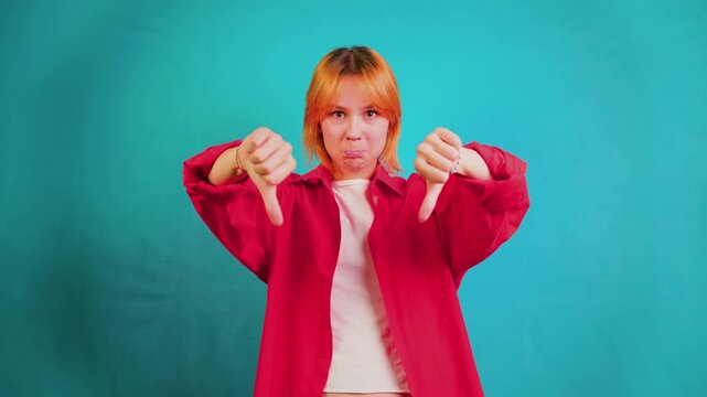 Expressive woman changing thumbs up to thumbs down