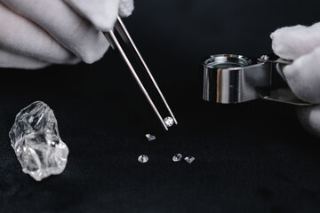 Meticulous jeweler quality check of gemstones, Inspecting diamonds with magnifier for grading