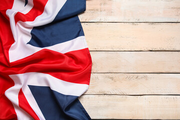 National flag of the United Kingdom on beige wooden background