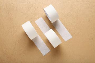 Rolls of white masking tape on brown background