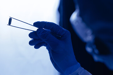 Scientist hold pill capsules for control medicine quality in pharmaceutical factory