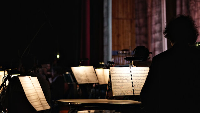 Illuminated music stands on orchestra stage before concert
