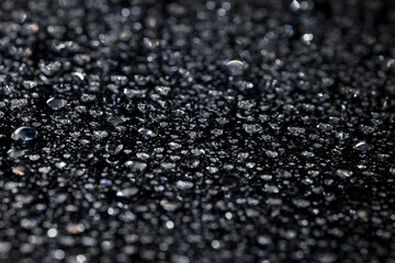 water drops on glass in close-up. abstract dark background with beautiful bokeh. Mockup for your logo. horizontal wallpaper or web banner.