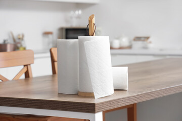 Rolls of paper towels on wooden table in kitchen