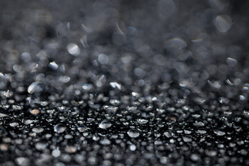 raindrops on a dark background.water drops on glass in close-up. Abstract dark background. Mockup for your logo. horizontal wallpaper or web banner.