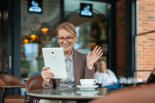 Senior woman smiling during video call on tablet
